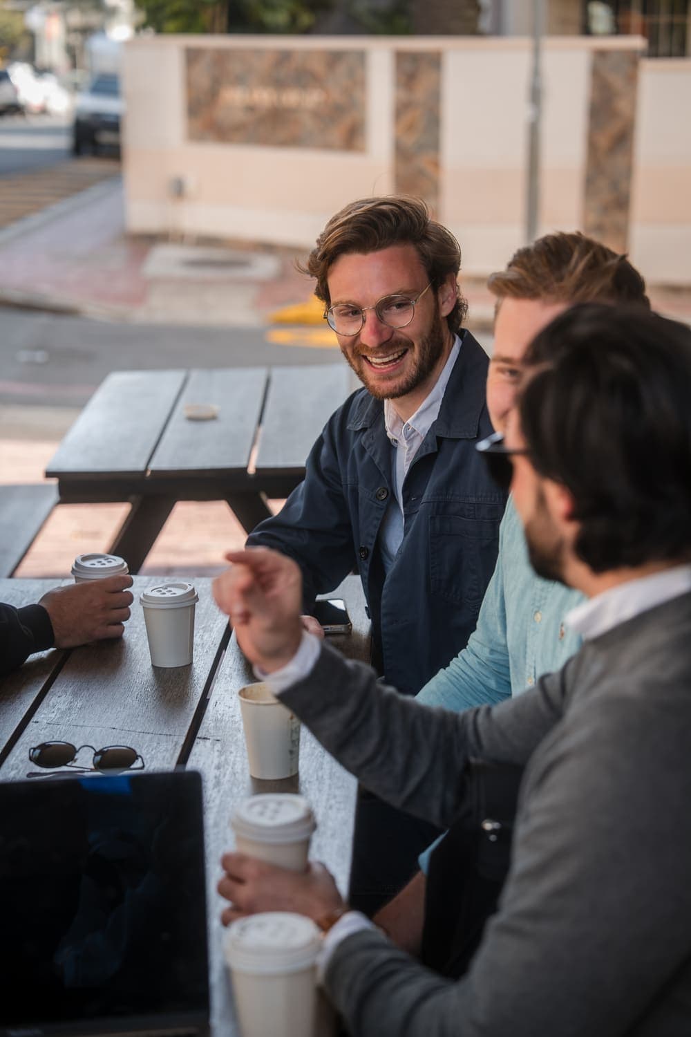 The Unyfy team laughing over coffee